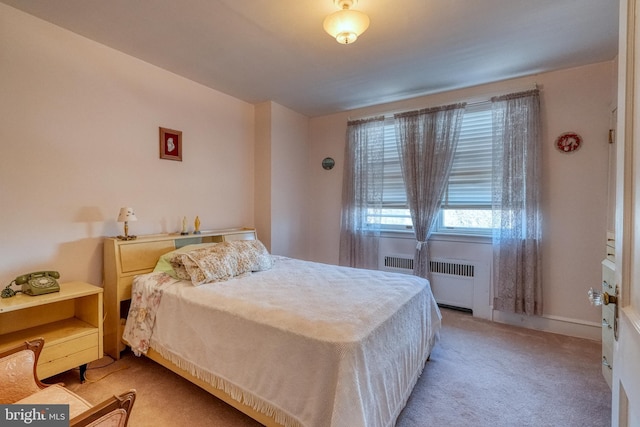 bedroom featuring radiator and light colored carpet