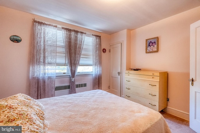 bedroom with carpet floors and radiator