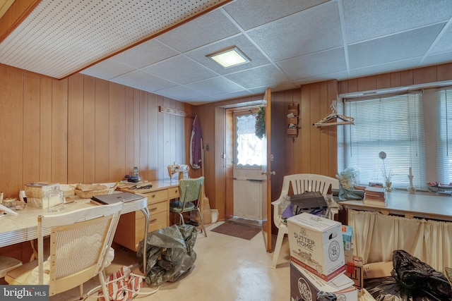 miscellaneous room with wooden walls and a drop ceiling