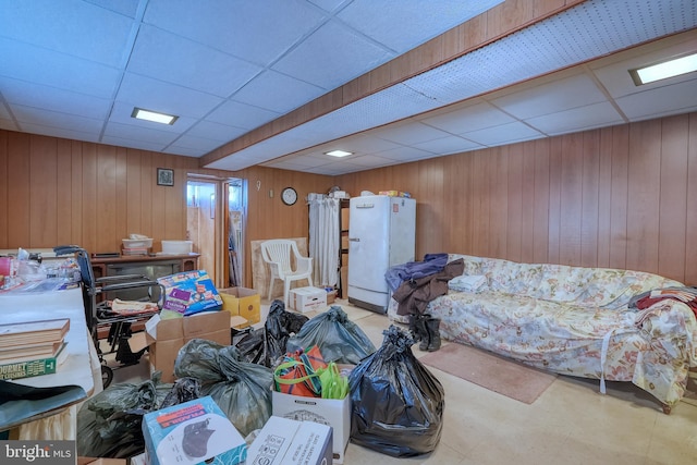 interior space featuring wood walls and a paneled ceiling