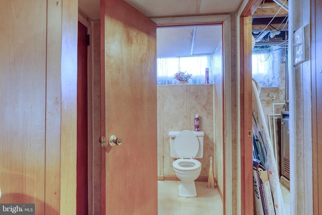 bathroom with tile patterned flooring and toilet