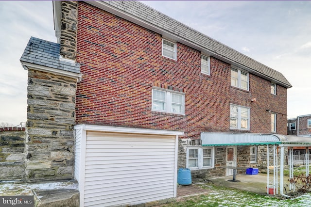 rear view of property with a garage