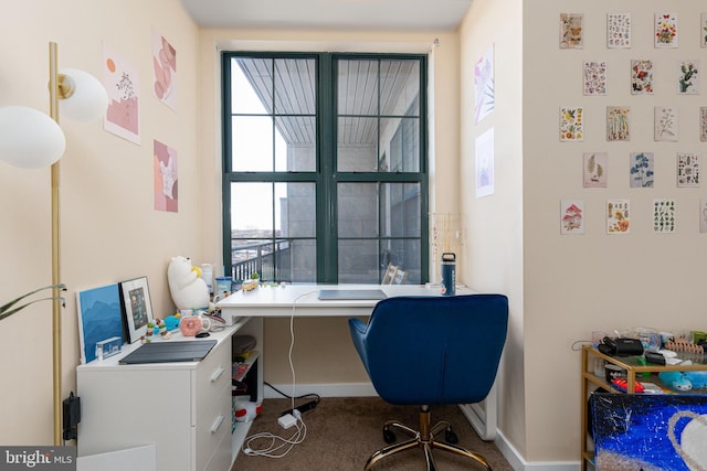 home office featuring carpet flooring and a wealth of natural light