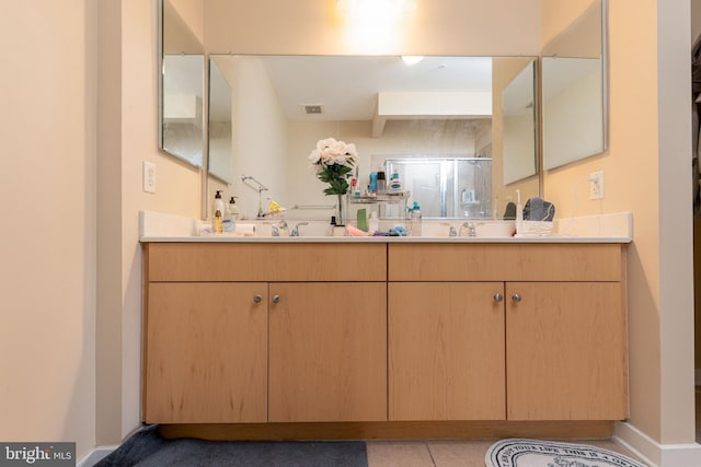 bathroom featuring tile patterned floors, walk in shower, and vanity