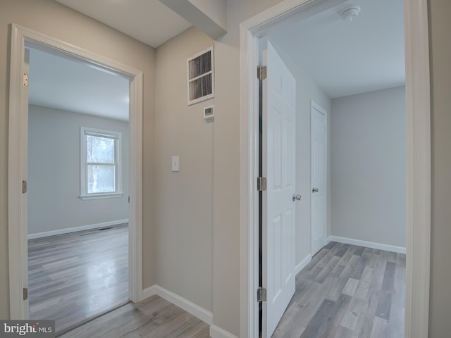 hall with light wood-type flooring