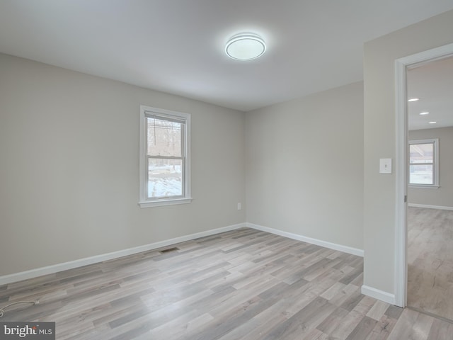 spare room with light hardwood / wood-style flooring