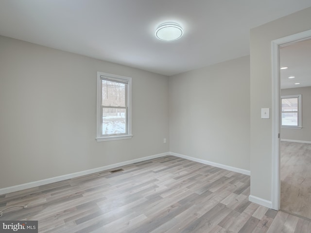 unfurnished room featuring light hardwood / wood-style floors