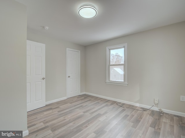 unfurnished room with light hardwood / wood-style flooring