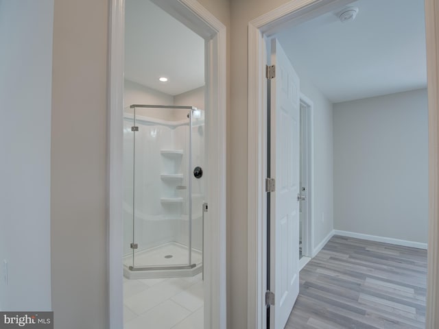 bathroom with hardwood / wood-style floors and walk in shower