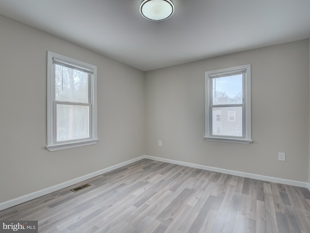 spare room with light hardwood / wood-style floors