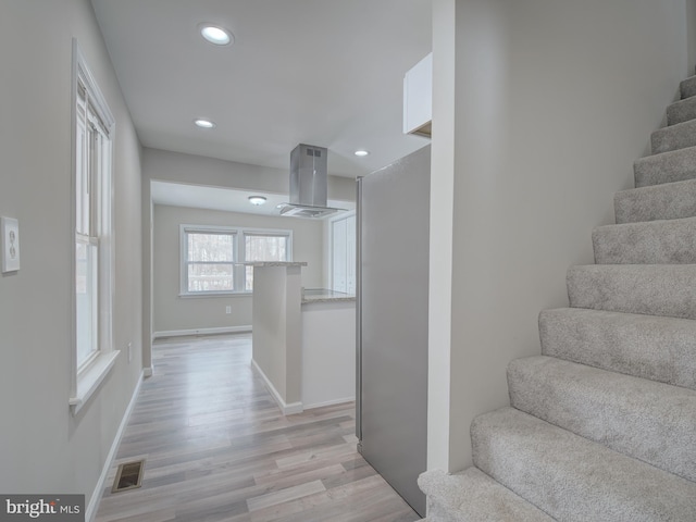 stairs with hardwood / wood-style floors