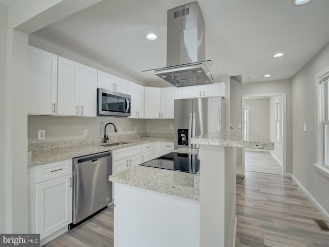 kitchen with white cabinetry, appliances with stainless steel finishes, sink, and island range hood