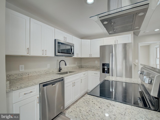 kitchen with stainless steel appliances, light stone countertops, sink, and white cabinets