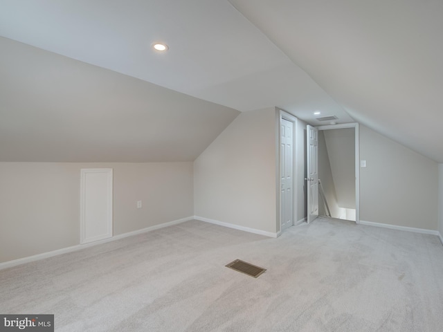 bonus room featuring light colored carpet and lofted ceiling