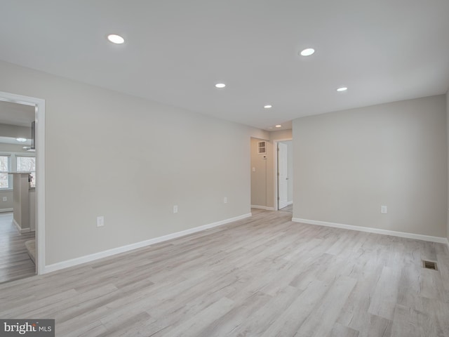 unfurnished room with light wood-type flooring