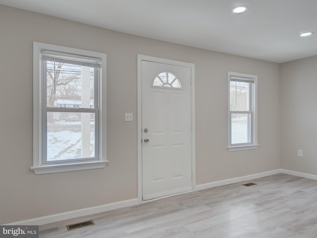 entryway with plenty of natural light and light hardwood / wood-style floors