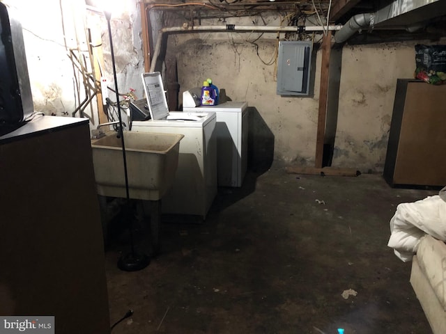 basement with refrigerator, sink, electric panel, and washer and clothes dryer