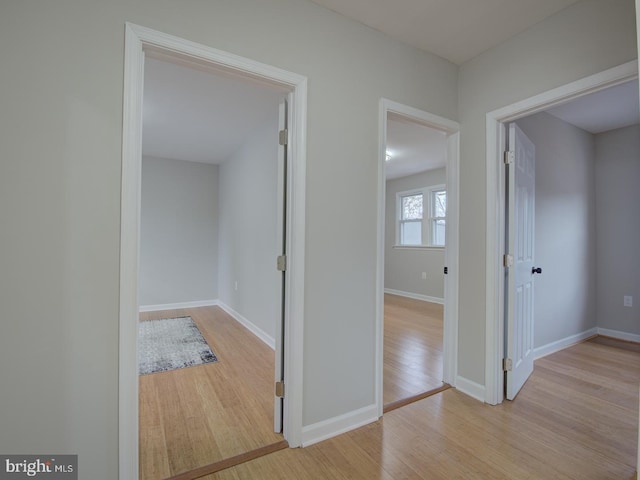 hallway with light hardwood / wood-style floors