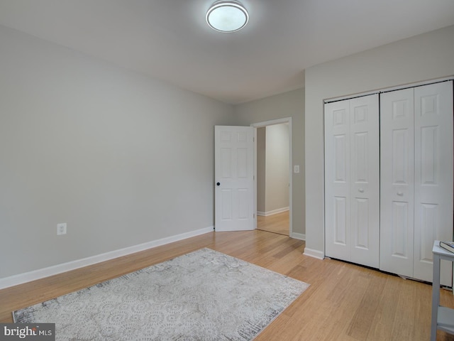 bedroom with a closet and light wood-type flooring