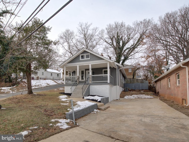 bungalow-style house featuring central AC and a porch