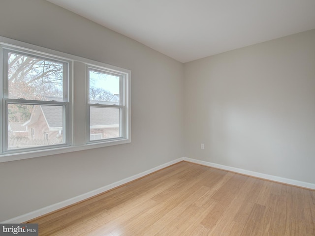 spare room with light hardwood / wood-style flooring