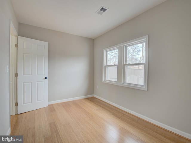 spare room with light wood-type flooring