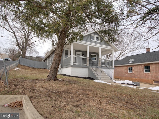 view of front of property with a front yard and covered porch