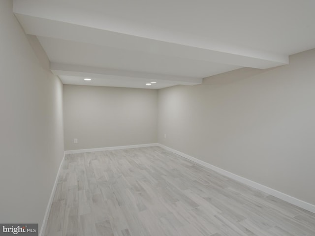 basement with light hardwood / wood-style flooring