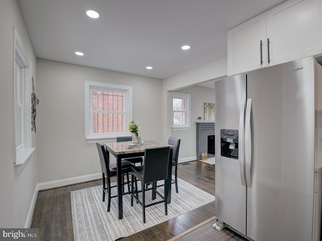 dining room featuring hardwood / wood-style flooring and a fireplace