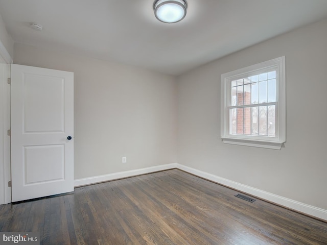 unfurnished room with dark hardwood / wood-style floors