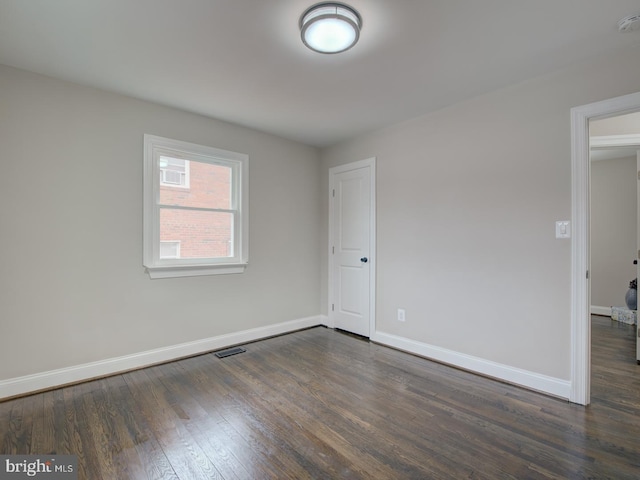 empty room with dark hardwood / wood-style floors