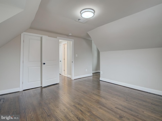 bonus room featuring dark hardwood / wood-style flooring and vaulted ceiling