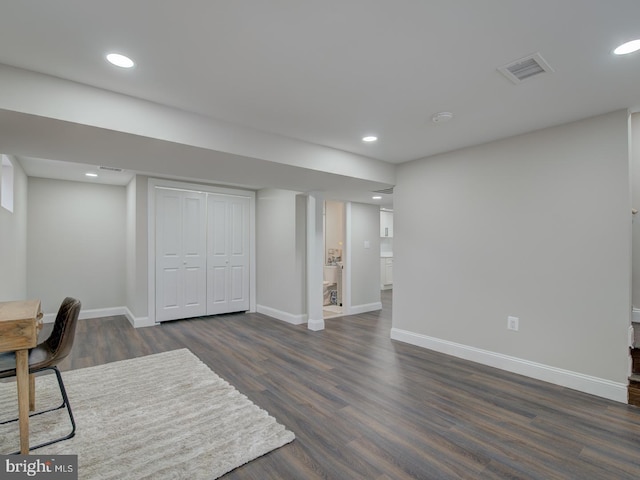 home office with dark wood-type flooring