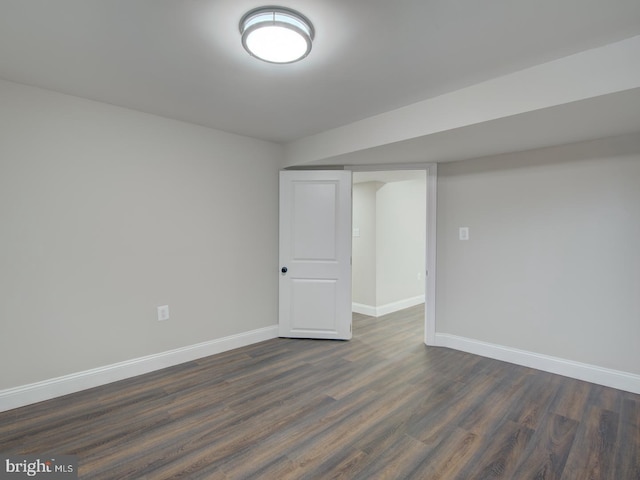 spare room with dark wood-type flooring