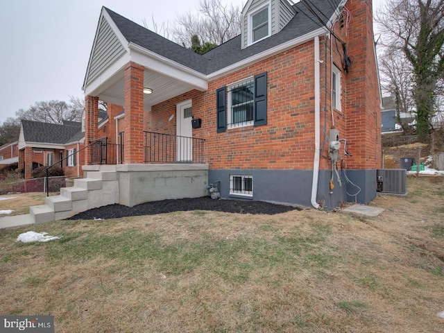 view of home's exterior featuring cooling unit and a yard