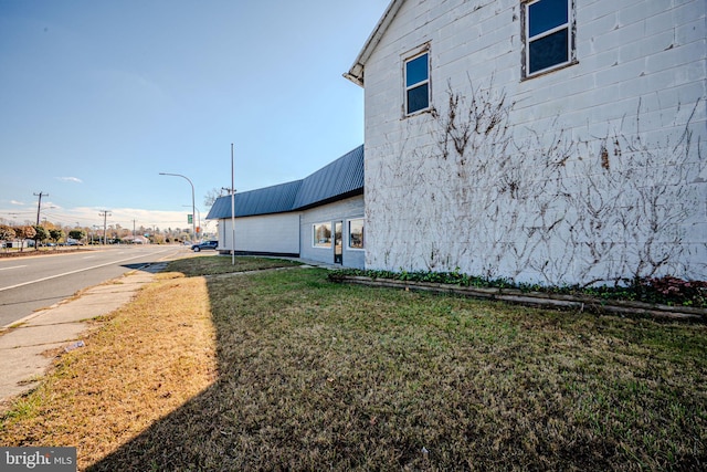 view of side of home featuring a lawn