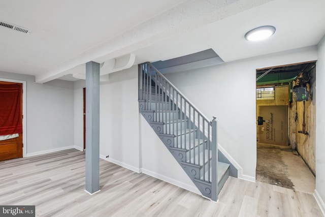 basement with light hardwood / wood-style floors