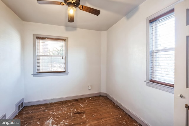 empty room featuring ceiling fan and dark hardwood / wood-style floors