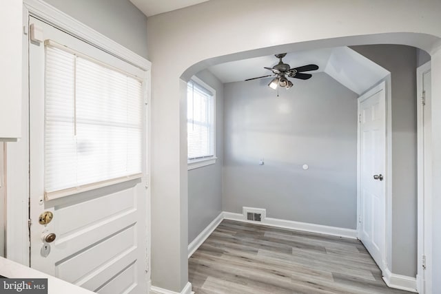 laundry room featuring ceiling fan and light hardwood / wood-style flooring