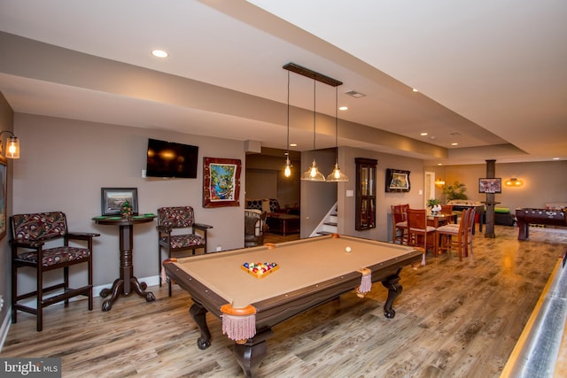 recreation room with a raised ceiling, billiards, and wood-type flooring