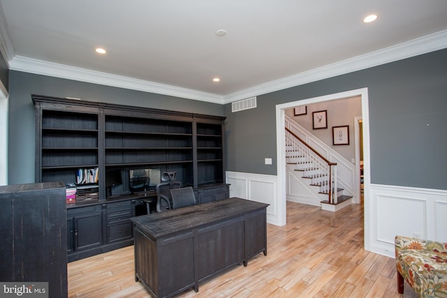 office area with light wood-type flooring and ornamental molding