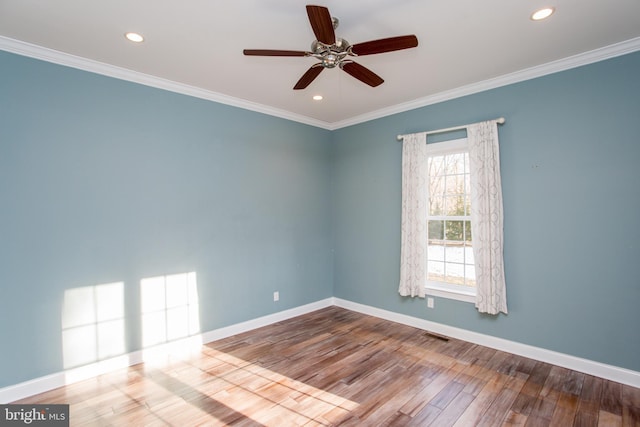 spare room with ceiling fan, crown molding, and hardwood / wood-style floors