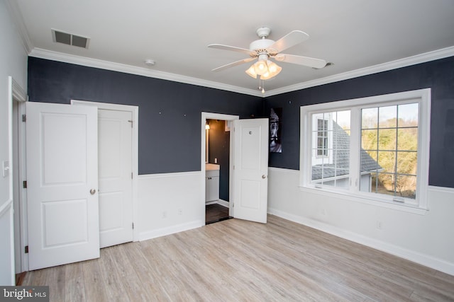 unfurnished bedroom featuring ceiling fan, a closet, ornamental molding, and light hardwood / wood-style flooring