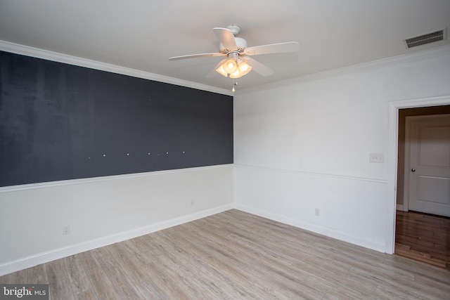 spare room featuring ceiling fan, crown molding, and light hardwood / wood-style flooring