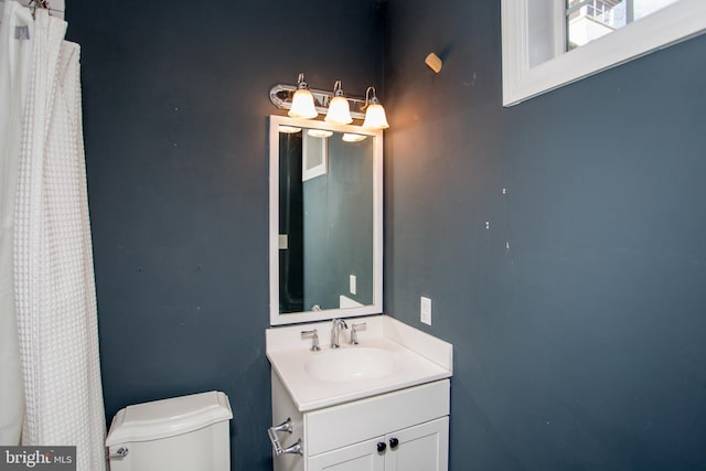 bathroom featuring toilet and vanity