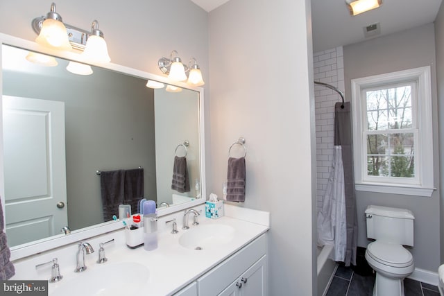 bathroom featuring toilet, vanity, and tile patterned floors