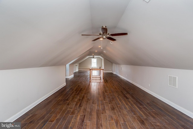 additional living space with ceiling fan, vaulted ceiling, and dark wood-type flooring