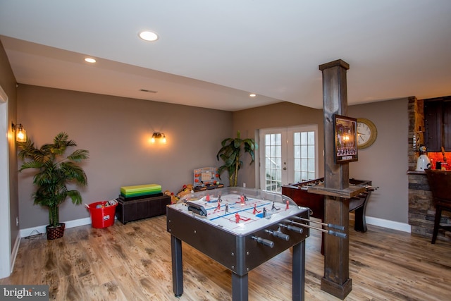 rec room with hardwood / wood-style floors and french doors