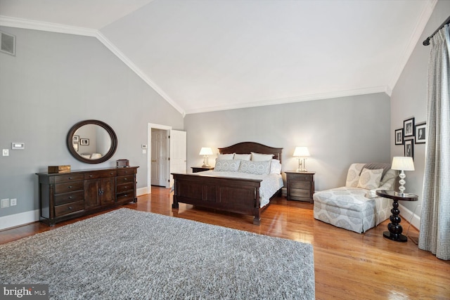 bedroom featuring crown molding, lofted ceiling, and wood-type flooring