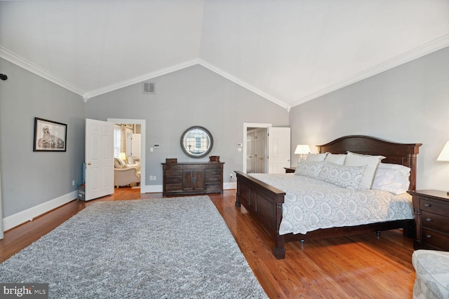 bedroom featuring ensuite bathroom, wood-type flooring, ornamental molding, and high vaulted ceiling